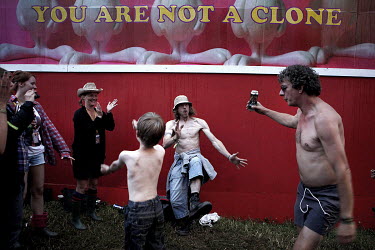 Dance music fans party in the 'Shangri La' area at the Glastonbury festival.