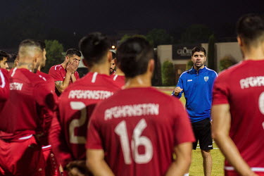 The Afghan national football team's head coach Anoush Dastgir gives a team briefing after a training session.