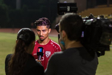 Hossein Zamani of the Afghan national football team, gives an interview to Afghan and Iranian television after a training session.