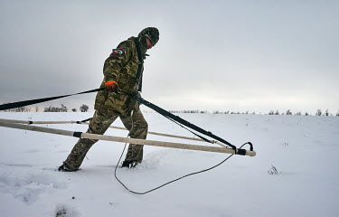 Victor, a volunteer for the Slavyansk Black Tulip humanitarian organization, which searches for the bodies of World War II soldiers, uses a metal detector to find possible sites for excavation. Soldie...