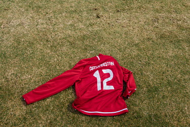 An Afghan national football team jersey lies on the pitch during a training session for the national team.