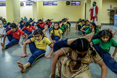 Students take part in a physical training activity on the first day of the school's reopening after a long period of closure due to COVID-19 restrictions.