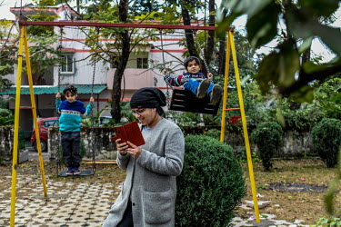 Anuradha, a single mother and a lawyer, uses her smartphone to keep working while taking her children, Ishita and Rudra, to the park for a break from their online studies. Due to COVID-19 restrictions...