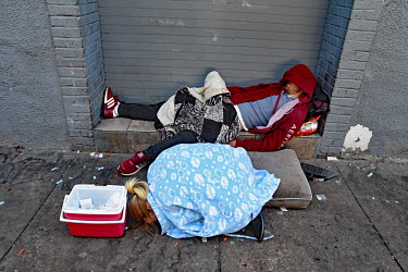 A couple, surrounded by drug injecting paraphernalia, passed out on a street in North Philadelphia, between Huntingdon and Allegheny on the elevated Market-Frankford subway. This is the epicentre of t...