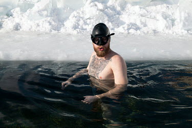 Egor Lesnoy, a blogger and activist from Irkutsk swims in a pool cut through the frozen surface of Lake Baikal. He took a great interest in diving and scuba diving in the lake and began to collect rub...