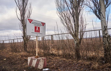 A sign on the road between Marinka and Krasnogorivka reads: 'Danger Mines. Don't leave the road! The area along the road is mined'.