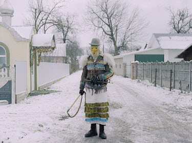 A person dressed-up in character for a rural winter carnival.