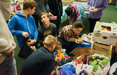 Children rummage through boxes full of toys brought to them by volunteers. Volunteers (during the eight years of the war in Donbas, many civic organizations were formed to help people in the combat op...