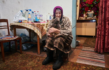 Lidiya Petrovna (87) holds her cat Matilda. Lidiya says that when the fighting was heavy, Matilda helped her survive the bombing. They held each others, waiting for breaks in the explosions. Ukrainian...
