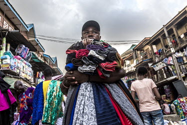 A street vendor selling fabric around Oshodi market.