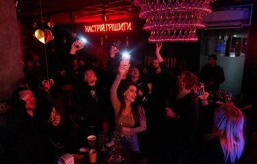 Young people dance in Biliy Naliv (White Filling), a Ukrainian cider bar. When asked many answer that they don't believe that there will be a Russian invasion of Ukraine.