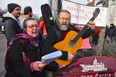 Left wing activists sign and play guitar at a counter demonstration during a rally for far right presidential candidate Eric Zemmour.
