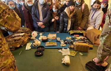 Civilians look at a display of first aid equipment as the Azov Battalion conducted military training for citizen volunteers. About hundred people learned first aid and how to use rifle. It was the fir...