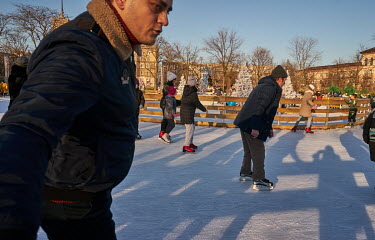 Cold but sunny weather brought people out into a park and an ice rink.