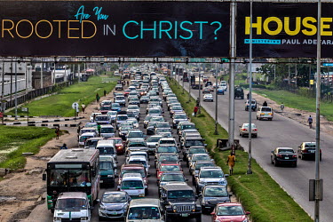 An advertisement for an evangelical Christian church above the traffic-choked Lekki- Epe expressway way.