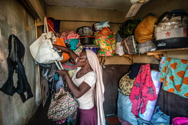 Saidat Bunmi Ayanwole, a street vendor in the Idumota market, inside the 3x3 metre room she shares with five other women on Lagos Island.