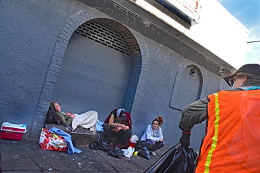 A street cleaner passes a group of homeless people on the street in North Philadelphia, between Huntingdon and Allegheny on the elevated Market-Frankford subway. This is the epicentre of the city's op...