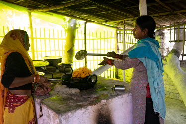 Women frying vermicelli on a smokeless stove.