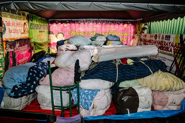 Bales of clothes that are yet to be sorted into different piles at Mad X Station. Items of designer value that can be saved are taken out for cleaning and ironing to be sold online later. People in Ma...