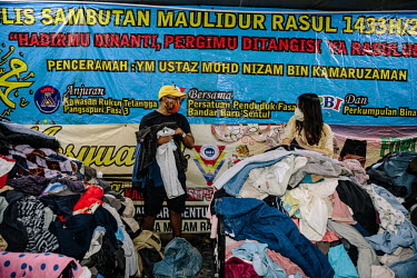 Amirul Ruslan and Catherine Liew shopping in Mad X Station bundle shop in the city. People in Malaysia use the term 'bundle' for secondhand shopping, a reference to the large bales that local clothing...