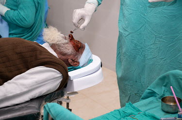 Preparing a male patient for cataract surgery.