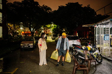 Catherine Liew and her friend, Amirul Ruslan with his shopping after a visit at Mad X Station bundle shop in the city. People in Malaysia use the term 'bundle' for secondhand shopping, a reference to...