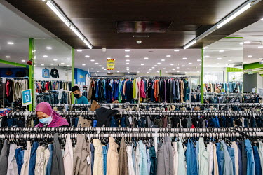 Shoppers at Family Bundle, a more upmarket version of a second hand thrift shop. People in Malaysia use the term 'bundle' for secondhand shopping, a reference to the large bales that local clothing me...