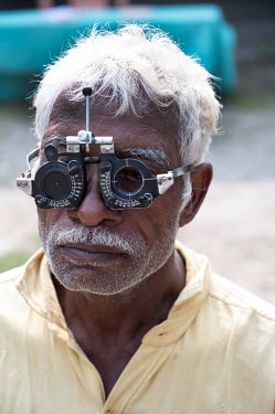 Older man havs his vision tested.