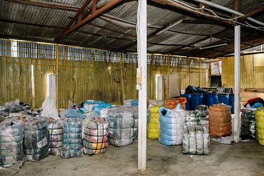 Bundle Murah, a small secondhand store on the outskirts of the city. Bales of clothes to be sorted in the rear end of the shop. People in Malaysia use the term 'bundle' for secondhand shopping, a refe...
