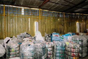 Bundle Murah, a small secondhand store on the outskirts of the city. Bales of clothes to be sorted in the rear end of the shop. People in Malaysia use the term 'bundle' for secondhand shopping, a refe...