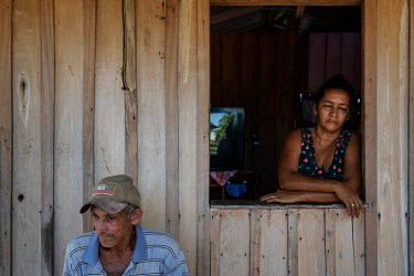 Farmer Jose de Assis (74) next to one of his four wives in his home on the Maloca rubber plantation in the Chico Mendes Extractive Reserve.