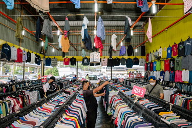 Sora Bundle, a long established secondhand store on the outskirts of the city. People in Malaysia use the term 'bundle' for secondhand shopping, a reference to the large bales that local clothing merc...