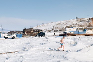 Tourists after swimming in an ice hole at the port of a closed fish factory in Khuzhir on Olkhon Island.