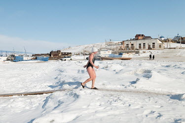 Tourists after swimming in an ice hole at the port of a closed fish factory in Khuzhir on Olkhon Island.