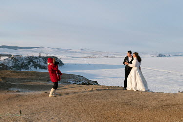 Newlyweds pose for a photo shoot at Cape Burkhan despite the temperature of -27 C