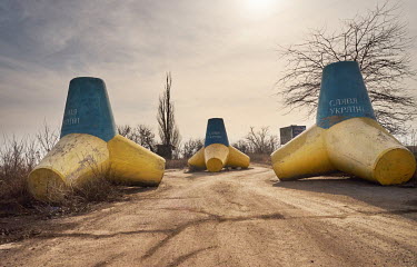 Anti-tank concrete tetrapods decorated with the Ukrainian colours and the slogan 'Glory to Ukraine', stand on the road to Yalta near Pionerske village. The frontline is just five kms from the village....