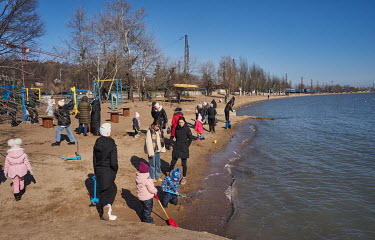 People enjoy the nice weather on the beach at New Pirs despite two hours of non-stop shelling (from 4-6AM) in the villages of Shyrokine and Vodyane, not far from Mariupol and heard clearly in the subu...