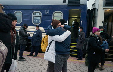 A couple say their goodbyes in front of the train that runs from Mariupol to Kyiv (Kiev). If people hear that road checkpoints are closed and they cannot leave Mariupol, they decide to go by train.Â�