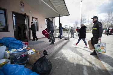 Resident's of the border town of Rejowiec-Kolonia arrive with donations of clothing and food at a school building that has been turned into a reception centre for people fleeing the Russian invasion o...