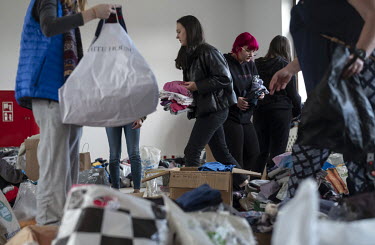 Resident's of the border town of Rejowiec-Kolonia arrive with donations of clothing and food at a school building that has been turned into a reception centre for people fleeing the Russian invasion o...