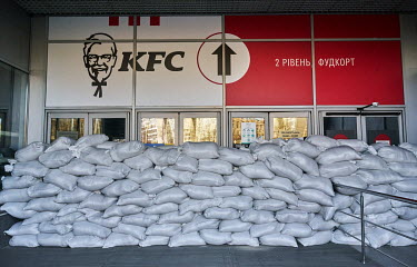 The entrance to a KFC protected by sandbags.