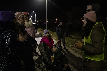 A group of women and children fleeing the Russian invasion of Ukraine arrive on Polish soil after crossing the Medyka â�" Shehyni border point get advice from volunteers. Many Poles and expatriate Uk...