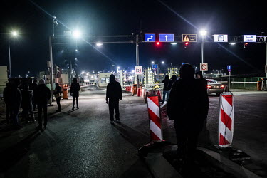 Polish volunteers and expatriate Ukrainians wait at the Medyka â�" Shehyni vehicle border crossing to assist arriving Ukrainian refugees fleeing the Russian invasion.