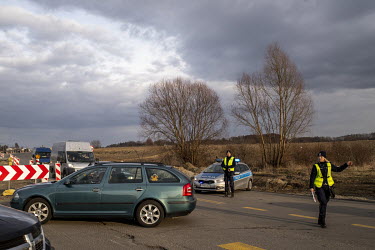 A police traffic control point set up to organise the movement around the Medyka border crossing as thousands of people arrived to pick up their families or simply to help the arriving refugees fleein...