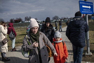 People fleeing the Russian invasion of Ukraine arrive on Polish soil after crossing the border. They are being met by many Poles and expatriate Ukrainians have also travelled with food, help with acco...