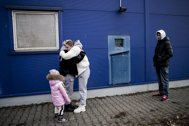 A Ukrainian family is reunited in a commercial centre car park which has become the main transit centre for refugees fleeing the Russian invasion of Ukraine.