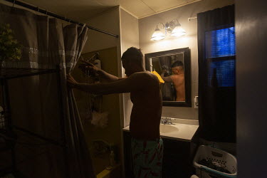 Daniel Montes (30), takes a shower after an eight hour shift harvesting on a grape farm.  Daniel Montes is in charge of the workers at a specific location. He can also work himself and make extra mone...