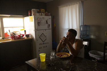 Daniel Montes (30), eats his dinner at home with his wife and daughter after an eight hour shift harvesting on a grape farm.  Daniel Montes is in charge of the workers at a specific location. He can a...