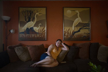 Marina Acosta (43) resting on her day off at her home in Fresno.   Marina has been working in the fields since she came to the USA about twenty years ago. She says she likes wearing sandals for work b...