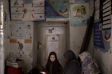 Women wait with their children to be seen by a health worker in a small clinic managed by UNICEF. Children from the village of Alibeg and surrounding area are being medically examined for malnutrition...